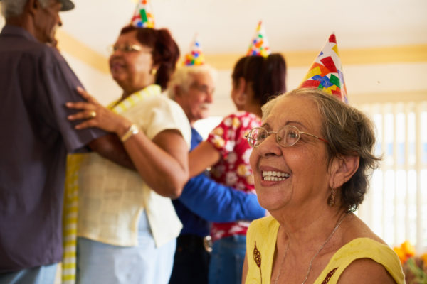 elderly Hispanic woman at birthday party