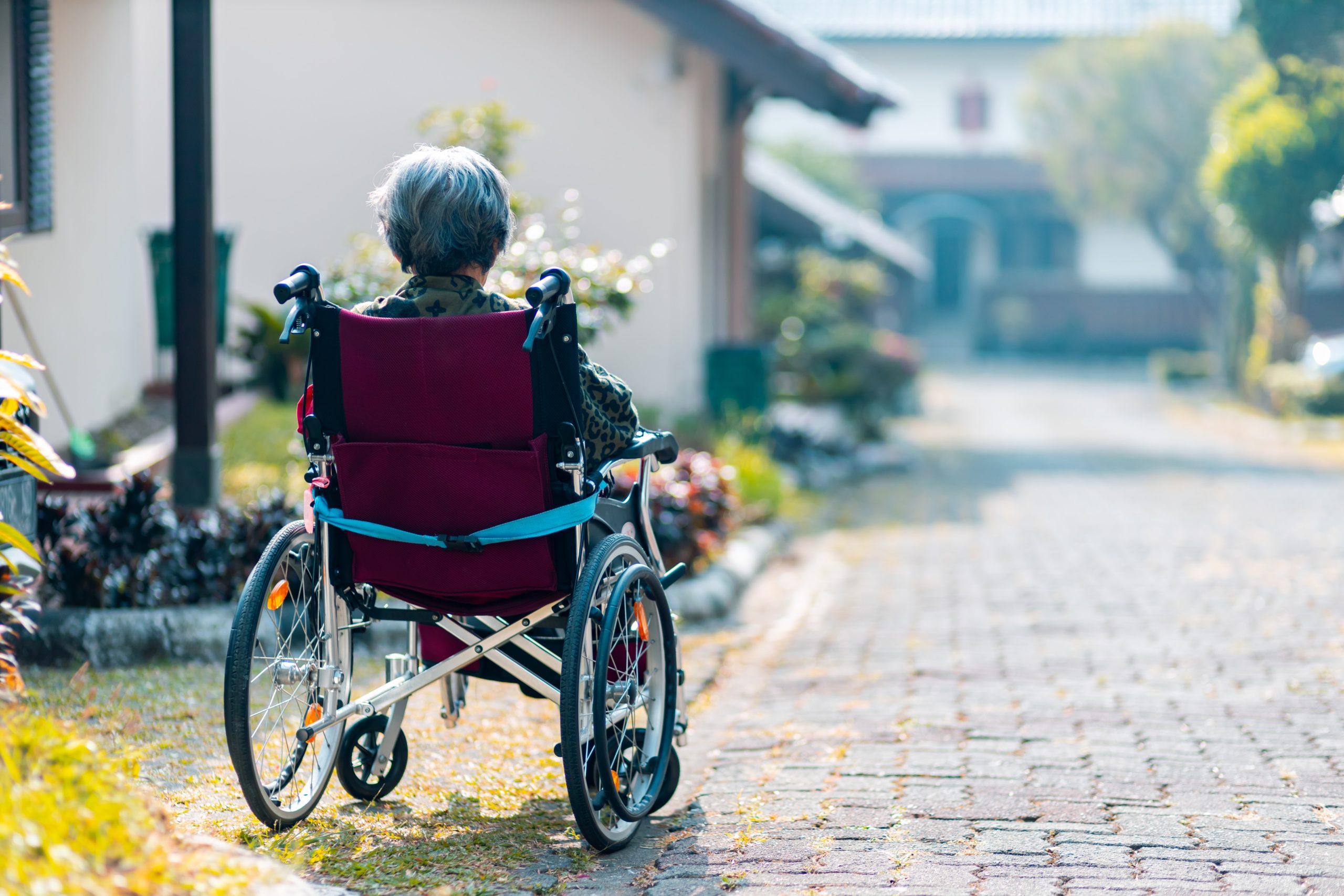 Older woman sitting in wheelchair outside